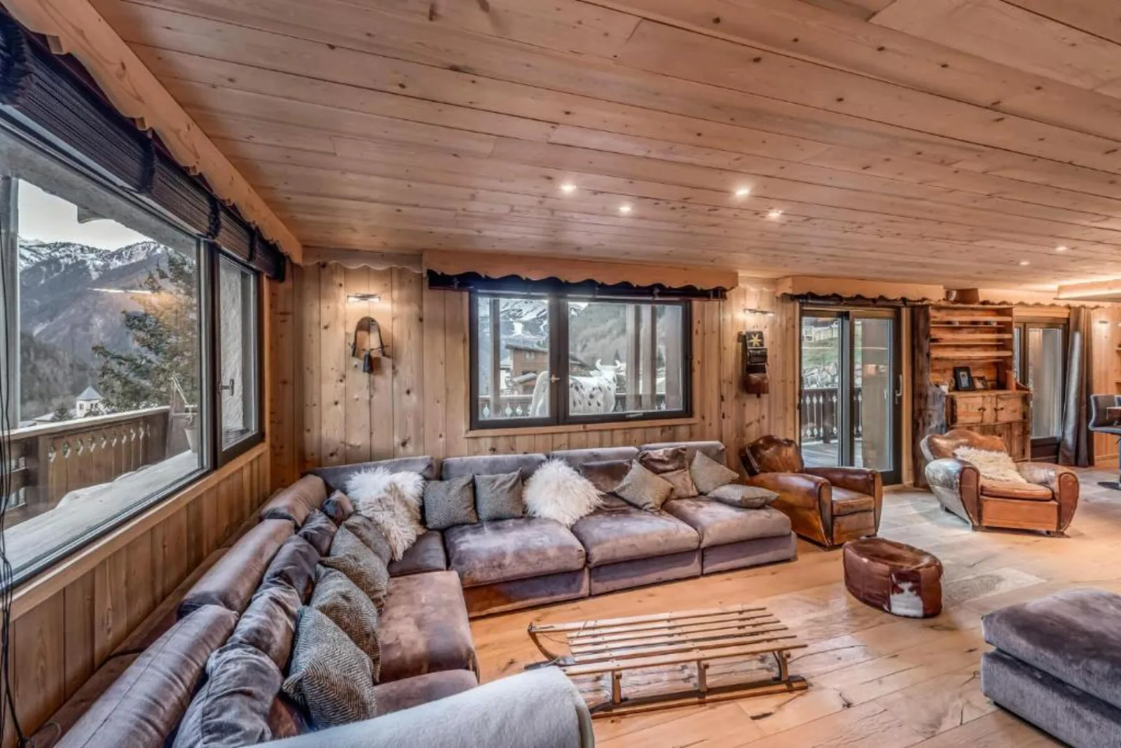 Le Grand Bouquetin living room with L-shaped sofa and mountain view through large windows