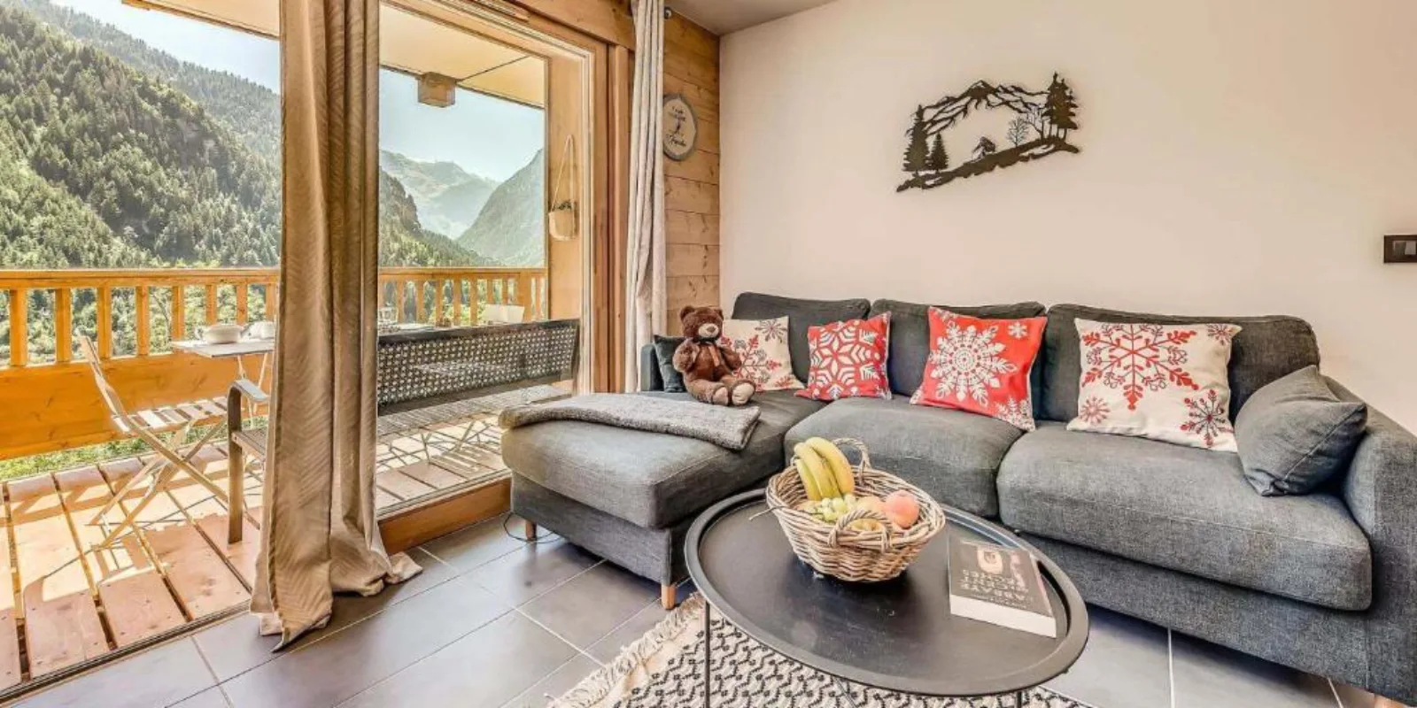 Les Nouveaux Alpages de Champagny stone-and-wood residence with balconies under a bright winter sun